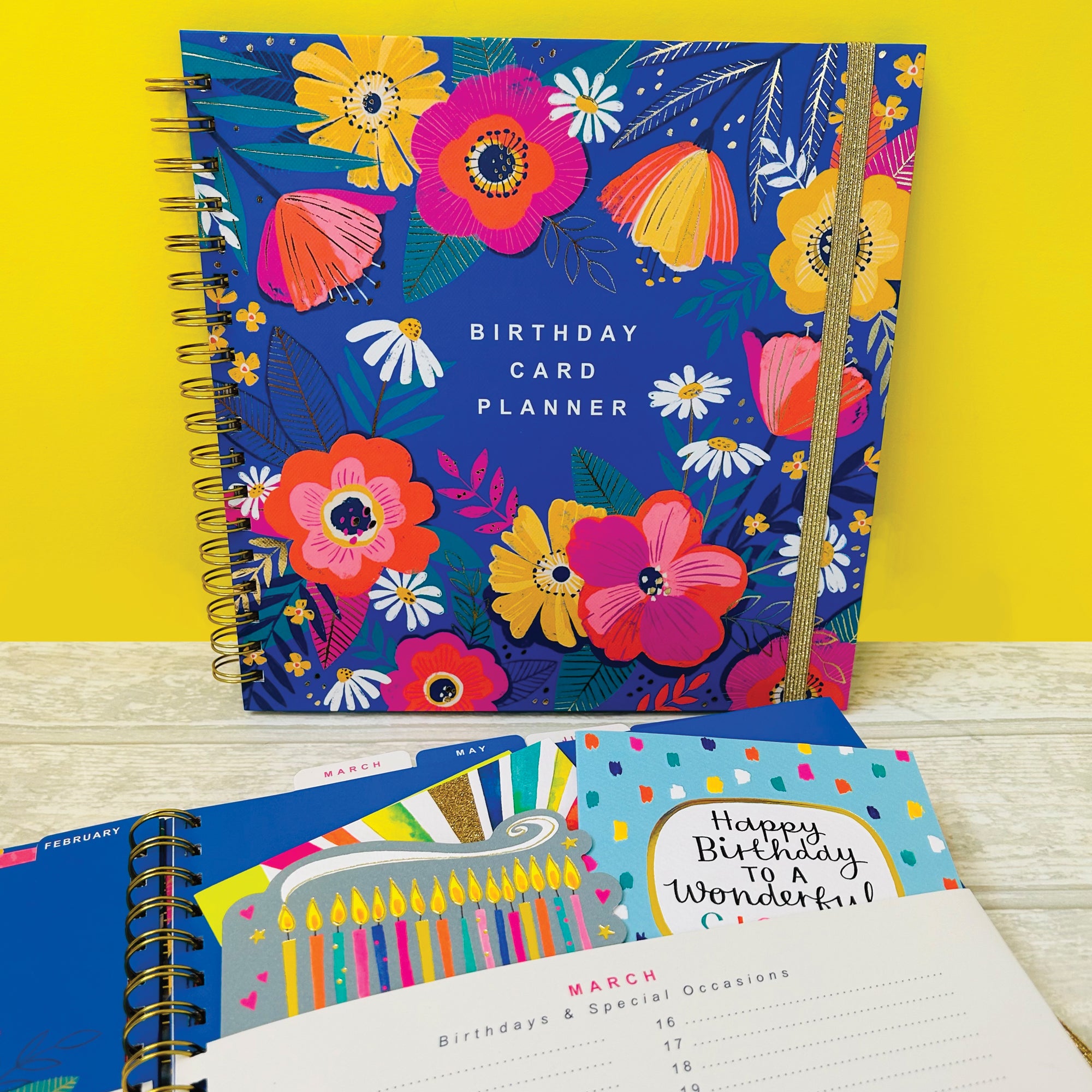 Close-up of wire binding and gold elastic closure on floral greeting card organise