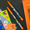 Decorative pen with Halloween-themed design on a black surface with Halloween-themed stickers.