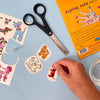 Playful pups tattoo set with scissors and packaging on a blue background